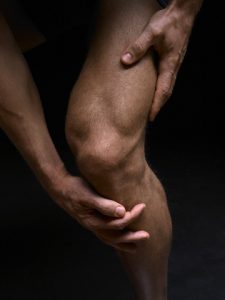 Man Holding His Knee